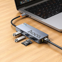 Заредете изображение във визуализатора на галерията – Adapter HUB 8w1 (HDTV+RJ45+SD/TF+PD+Type-C 3.0+USB 3.0 x 2) USB-C Hoco HB52 grey
